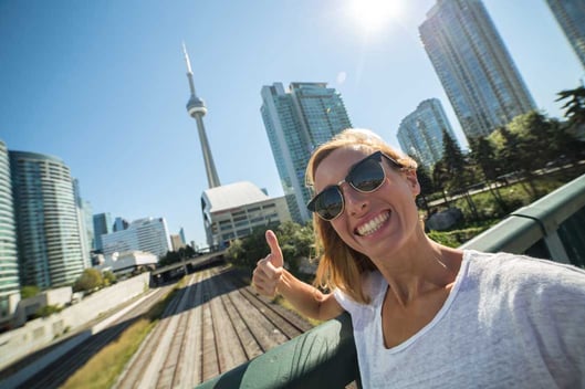 Young happy woman taking selfie in Toronto
