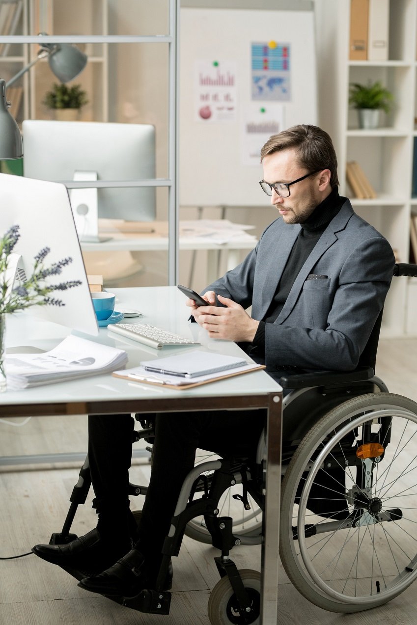white business person wheelchair smartphone