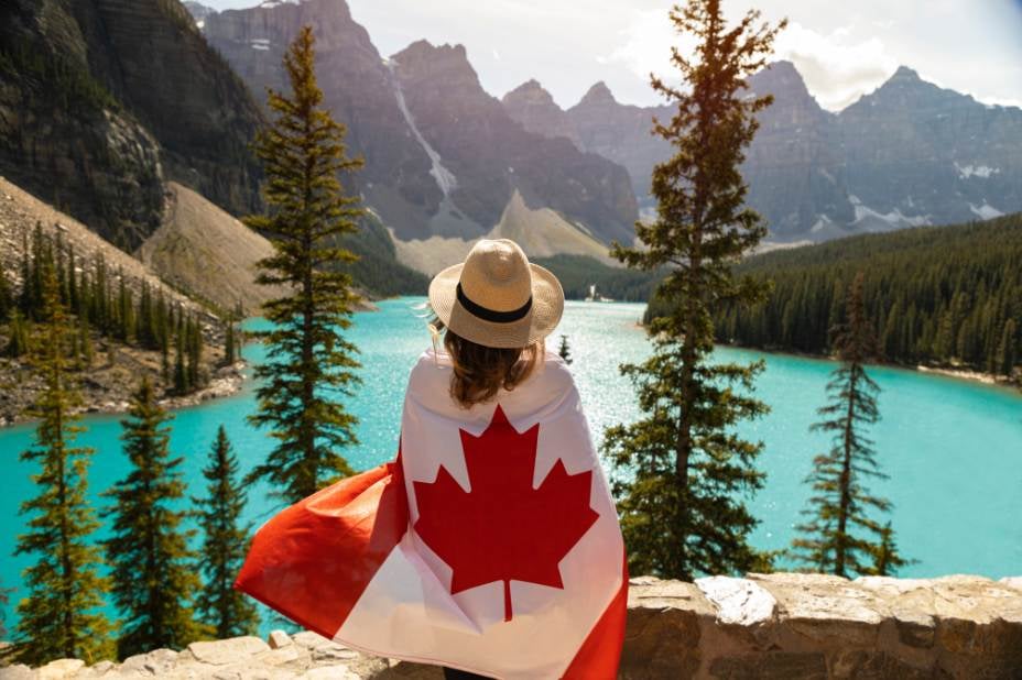 woman with canadian flag hiking