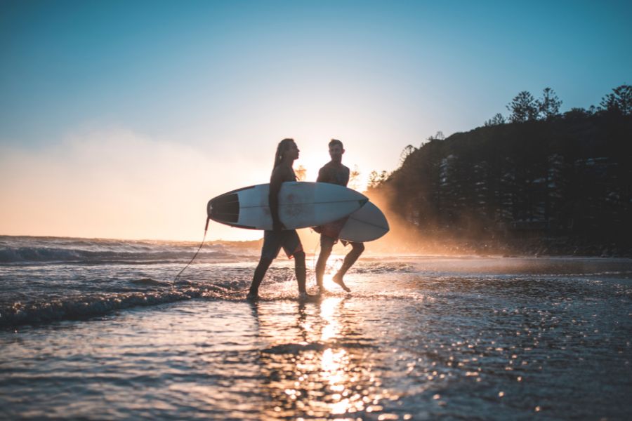 couple surfing in australia