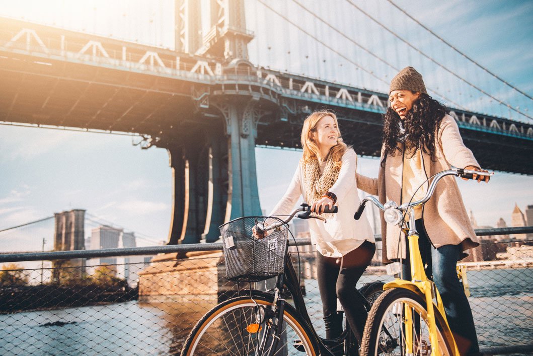 Female friends on bicycle ride in New York