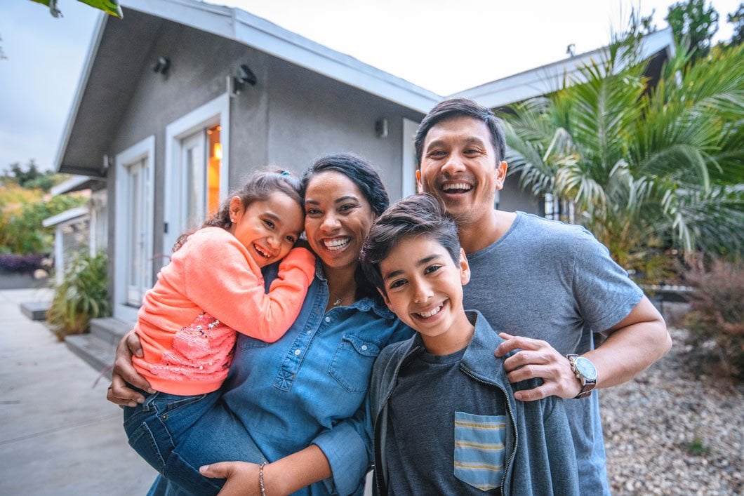Happy family outside home in california